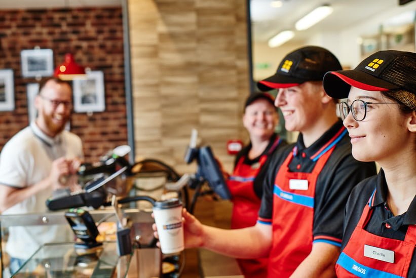 Staff serving a customer at Greggs